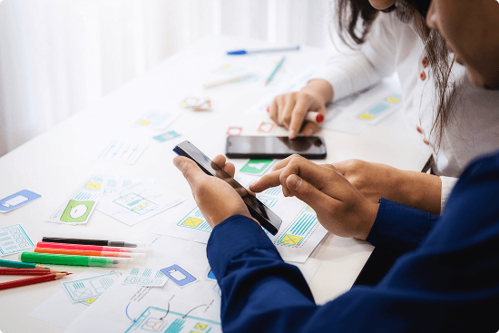 software-developers-working-while-using-mobile-phone-table 1 (1) 1